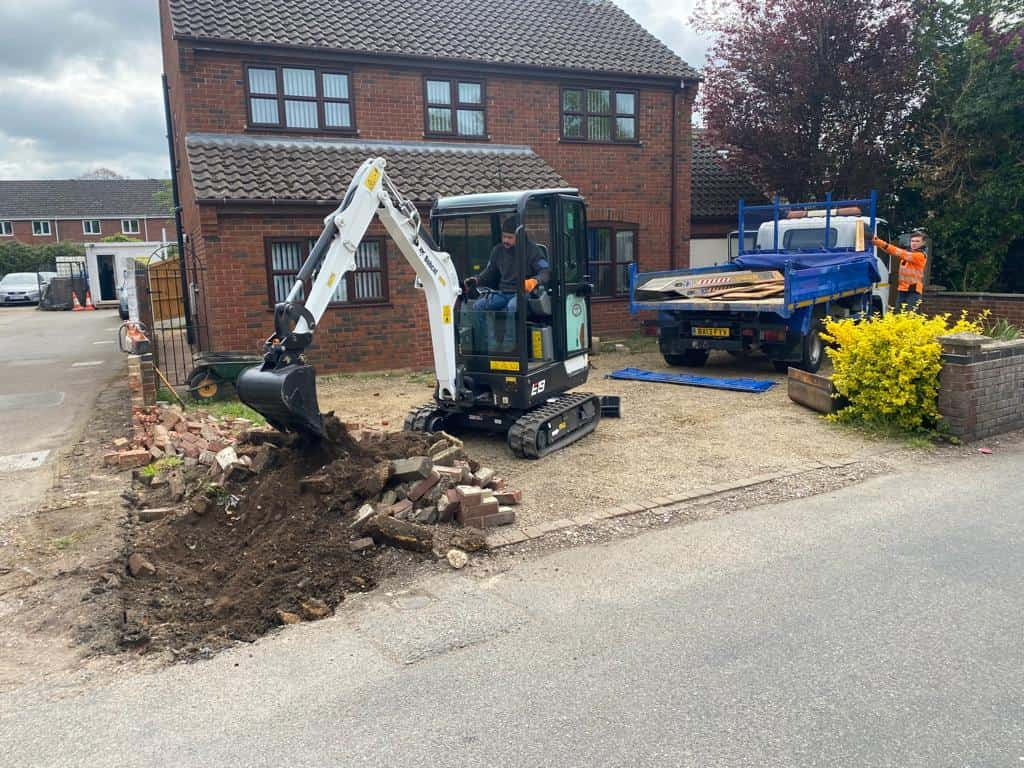 This is a photo of an operative of Cranfield Driveways Digging out for a new tarmac driveway