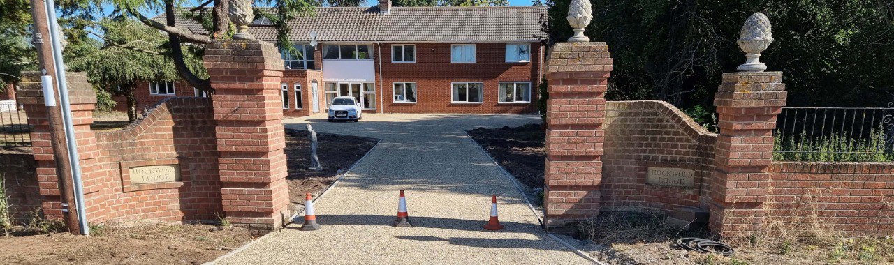 This is a photo of a newly installed chip and tar driveway, installed by Cranfield Driveways